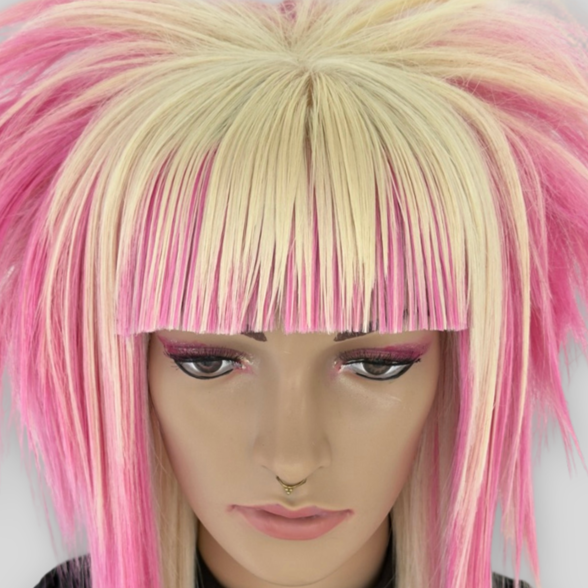 Close up view of emo scene wig in platinum blonde, pastel pink, featuring spiky, choppy layers and a soft, sleek texture. A bold fashion statement for Harajuku, scenecore, y2k, kawaii, and alternative styles.