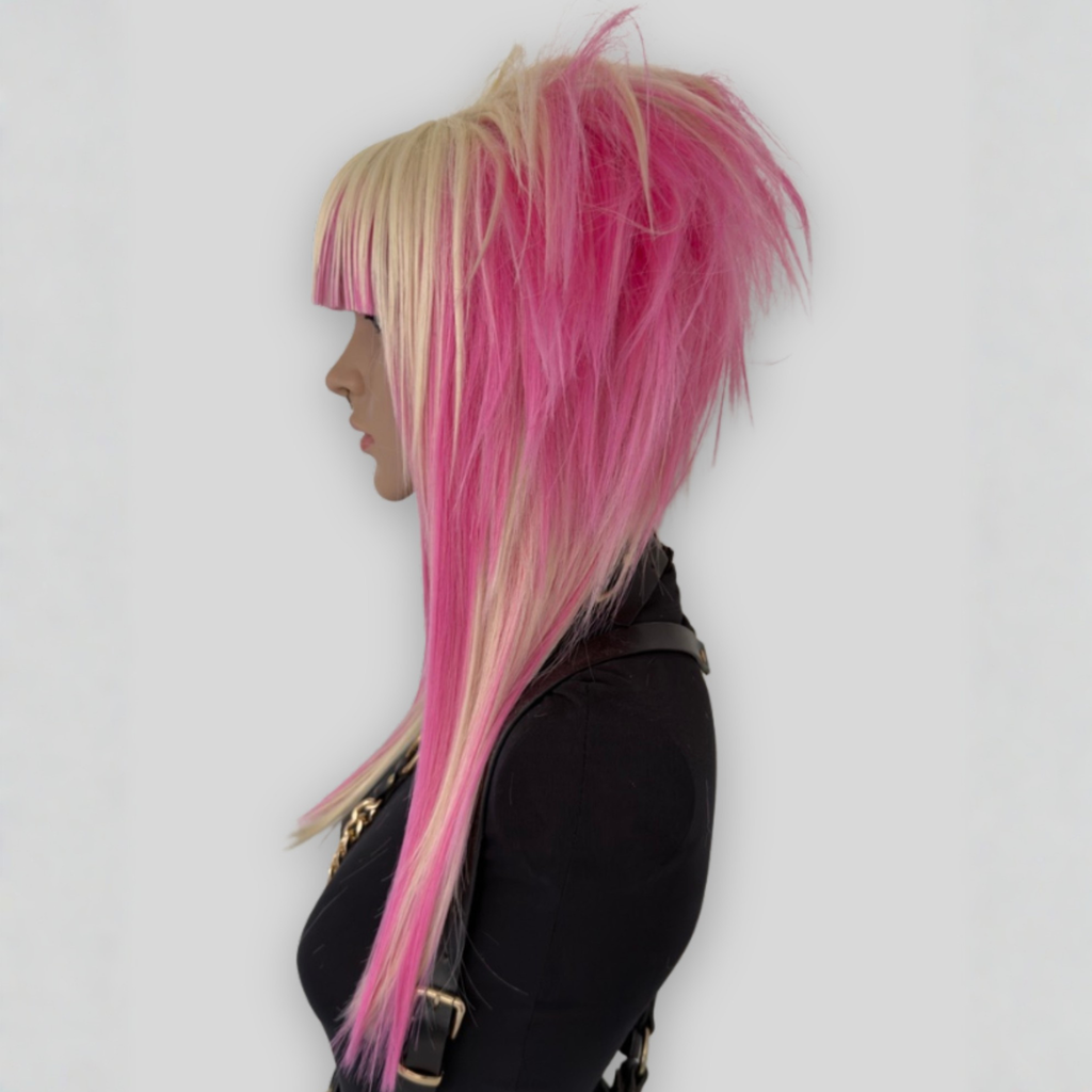 Side profile picture of platinum blonde and pastel pink cosplay wig with long layered strands and voluminous cut. A stylish synthetic wig perfect for alternative fashion and scenecore, y2k cosplay.