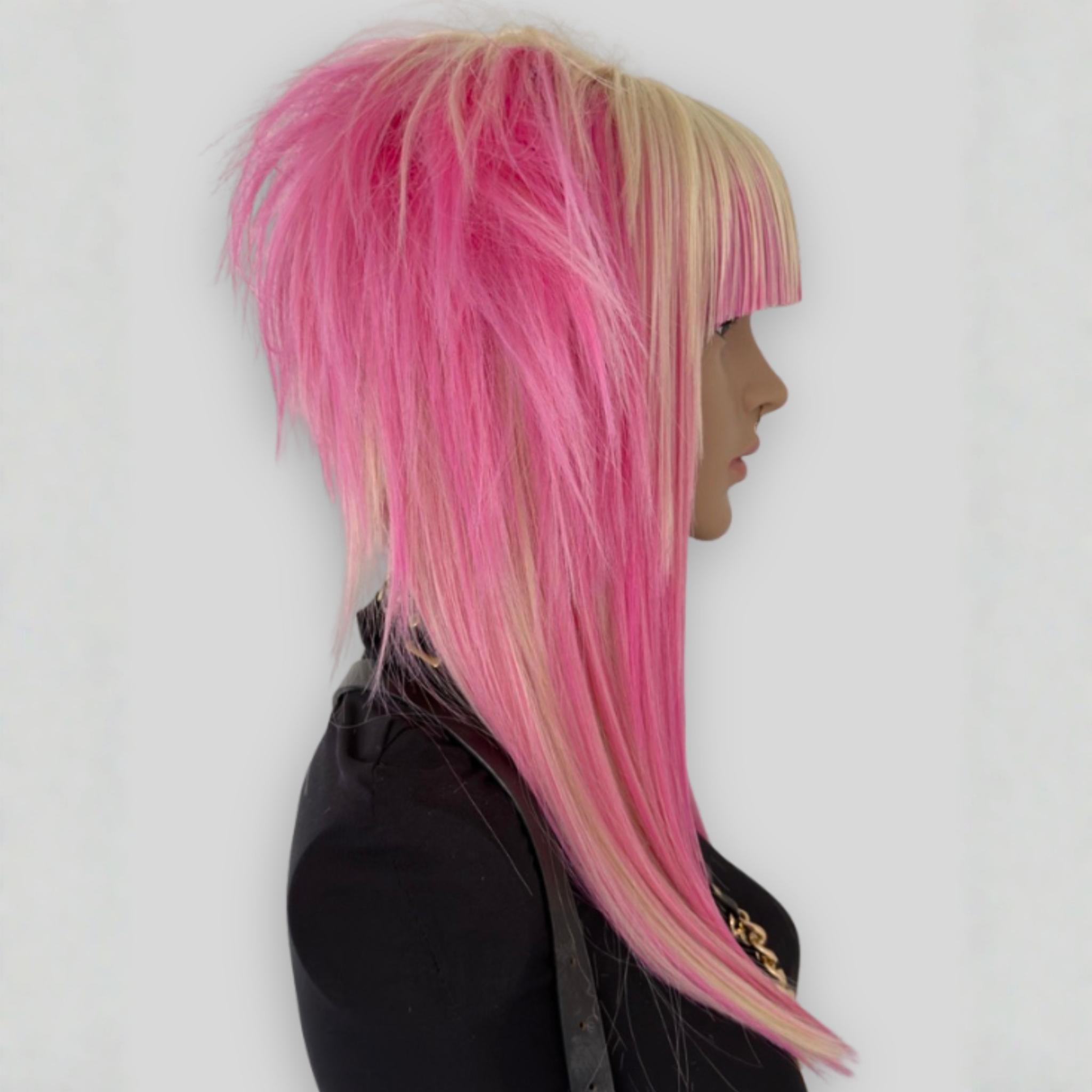 Right side profile picture of platinum blonde and pastel pink cosplay wig with long layered strands and voluminous cut. A stylish synthetic wig perfect for alternative fashion and scenecore, y2k cosplay.